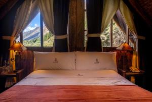 a bedroom with a bed with a view of a mountain at Hacienda Hostería Dos Chorreras in Cuenca