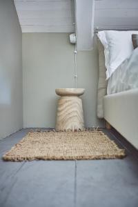 a rug on the floor next to a bed at AQVAE Unconventional Country House in Oglianico +79 photos