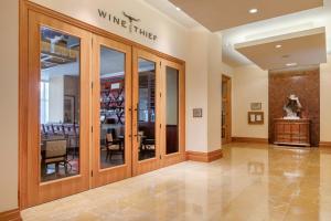 a wine store with glass doors and a dining room at Omni Fort Worth Hotel in Fort Worth +98 photos
