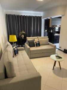 a living room with a couch and a table at Precioso apartamento con terraza y piscina in Rio de Janeiro