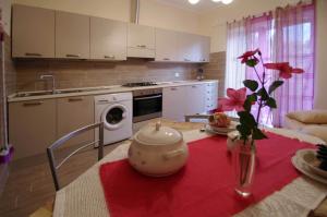 a kitchen with a table with a tea pot on it at Il Mulino del Castello in Garlenda +12 photos