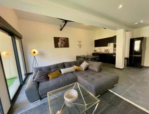 a living room with a couch and a table at Residence Belfort in Le Mans