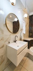 a bathroom with a sink and a mirror at The Lux Guesthouse in Kroonstad