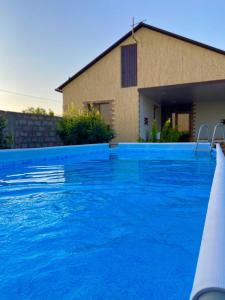 a swimming pool in front of a house at Voskevaz Rest in Voskevaz