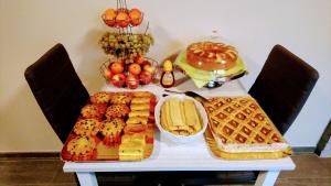 a table with bread and waffles and other foods on it at L'Isola Dla Cerrea in Mombasiglio