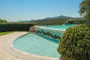 a swimming pool in the middle of a yard at Villetta d'Arancia - SHERDENIA Luxury Apartments in Santa Marinella