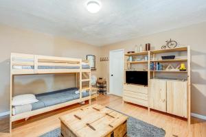 a bedroom with two bunk beds and a tv at Tahoe Treetop Escape in Stateline