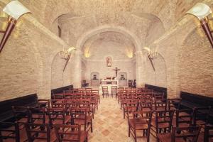 an empty church with chairs and a altar at Masseria Pietrafitta in Foggia