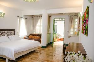 a bedroom with a bed and a table at El Despertar Hotel in Jericó +84 photos