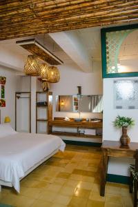 a bedroom with a large bed and a bathroom at El Despertar Hotel in Jericó