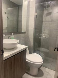 y baño con aseo, lavabo y ducha. en Apartaestudio Galerias LOFT 2051, en Bogotá