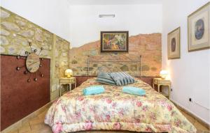 a bedroom with a large bed with two tables at Awesome Apartment In Chianni With Wifi in Chianni