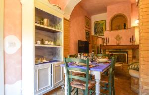 a dining room with a blue table and chairs at Awesome Apartment In Chianni With Wifi in Chianni