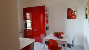 カリアリにあるLuxury residence in Cagliariの赤いキッチン(テーブル付)