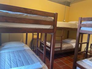 a room with two bunk beds and a bed at Hostal Casa Astromelia in Bogotá