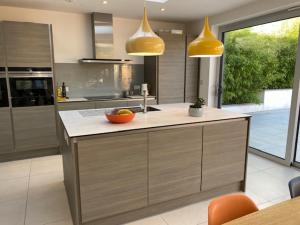a kitchen with a island with a bowl of fruit on it at 72 Ashley Road in Newmarket