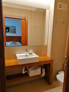a bathroom with a sink and a mirror at HOTEL ISLA PLANA in Tabarca