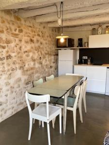 a dining room table and chairs in a kitchen at Les gites de la Vallée Noire in La Châtre