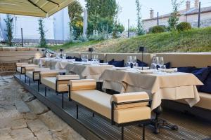 a row of tables and chairs at a restaurant at Martis Forum Heritage Hotel & Residence in Poreč