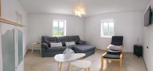 a living room with a couch and a table at Villa Flor Armenteira in Armentera