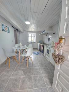 a kitchen and dining room with a table and chairs at Villa Flor Armenteira in Armentera +10 photos