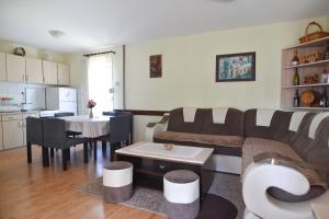 a living room with a couch and a table at Vila ZLATNI BOR in Zlatibor