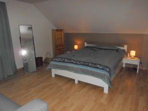 a bedroom with a bed and two tables and a mirror at Radlerquartier Edendorf in Itzehoe