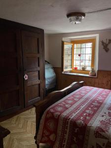 a bedroom with a bed and a window at Il Caso di Michael e Katia in Prazzo