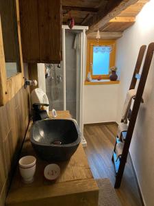 a bathroom with a black sink and a shower at Il Caso di Michael e Katia in Prazzo