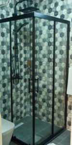 a shower with a glass door in a bathroom at Noya Köşk Otel in Adalar