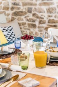 a table with plates and glasses of food and drinks at Holiday Home Vintage in Split
