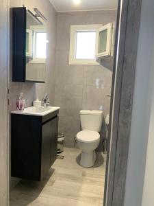 a bathroom with a toilet and a sink and a mirror at Paradise House in Ierapetra +7 photos