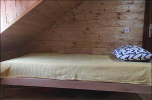 Cama en habitación con pared de madera en Kremanski čardak, en Kremna