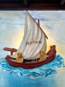 a painting of a boat in the water at Abrigo and Restaurant Portinho in Vila Praia de Âncora