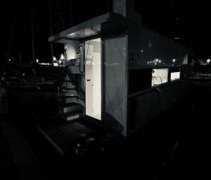 a building with a window on a boat at night at Different Charter in Vigo