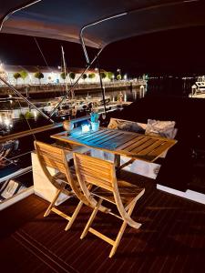 a table and chairs on the deck of a boat at Different Charter in Vigo