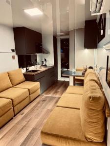 a living room with a couch and a kitchen at Different Charter in Vigo