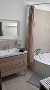 W łazience znajduje się wanna, umywalka i wanna. w obiekcie Maison avec piscine, jacuzzi et sauna privatifs - Mas de Nebbas w Aix-en-Provence +31 zdjęć