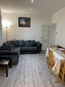 a living room with a couch and a table at London flat with garden in Catford