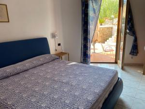 a bedroom with a bed and a door to a patio at La Vite in Ponza +46 photos