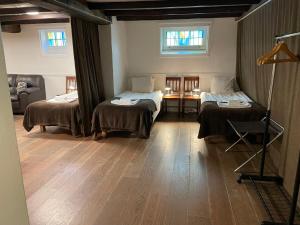 a room with two beds and a couch in it at Port Hotel Apartments in Karlshamn +14 photos