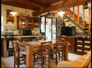 a kitchen with a wooden table and chairs at Villa vacanze floriana in SantʼAngelo in Lizzola