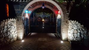 an entrance to a brick building with a gate with lights at Villa Captains in Formia