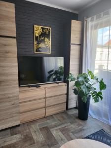 a living room with a large flat screen tv at Moon Apartments in Poznań