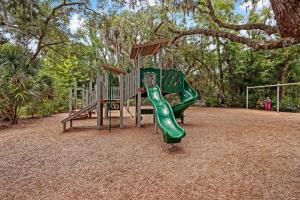 a playground with a green slide in a park at Omni Amelia Island Private Room at Courtside Villa-Minutes to Beach and Dining-2358 Boxwood Ln in Fernandina Beach