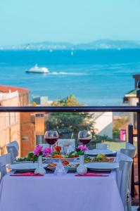 a table with plates of food and glasses of wine at Sarnic Hotel & Sarnic Premier Hotel(Ottoman Mansion) in Istanbul