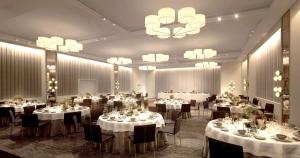 a banquet room with tables and chairs and a chandelier at The James New York - NoMad in New York