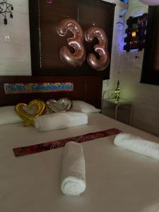 a hotel room with a bed with a couple of pretzels and a number at Ginebra Glamping in Ginebra