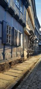 an empty street next to a blue building at Blauer Stieg in Quedlinburg