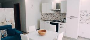 a kitchen with a table with a bowl on it at Nino's Apartments in Giardini Naxos